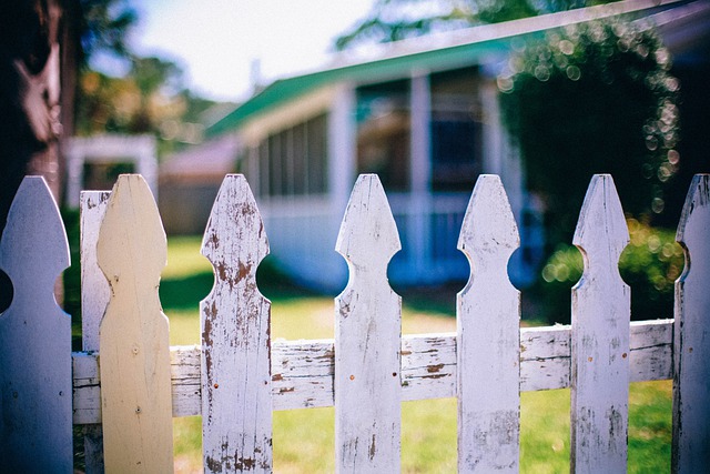 white picket fence by farmhouse